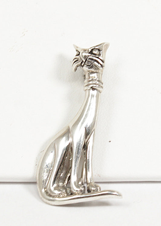 Silver cat-shaped brooch on a white background