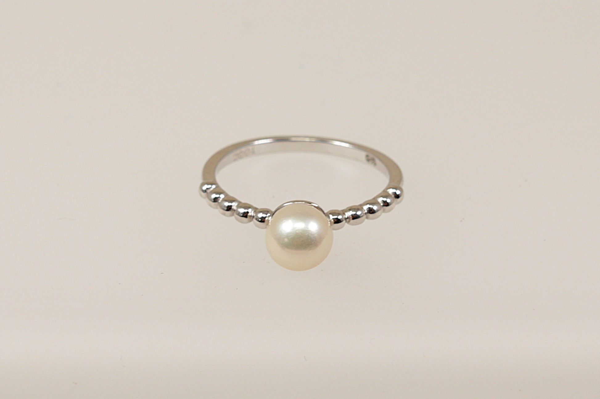 A sterling silver cultured pearl solitaire ring.