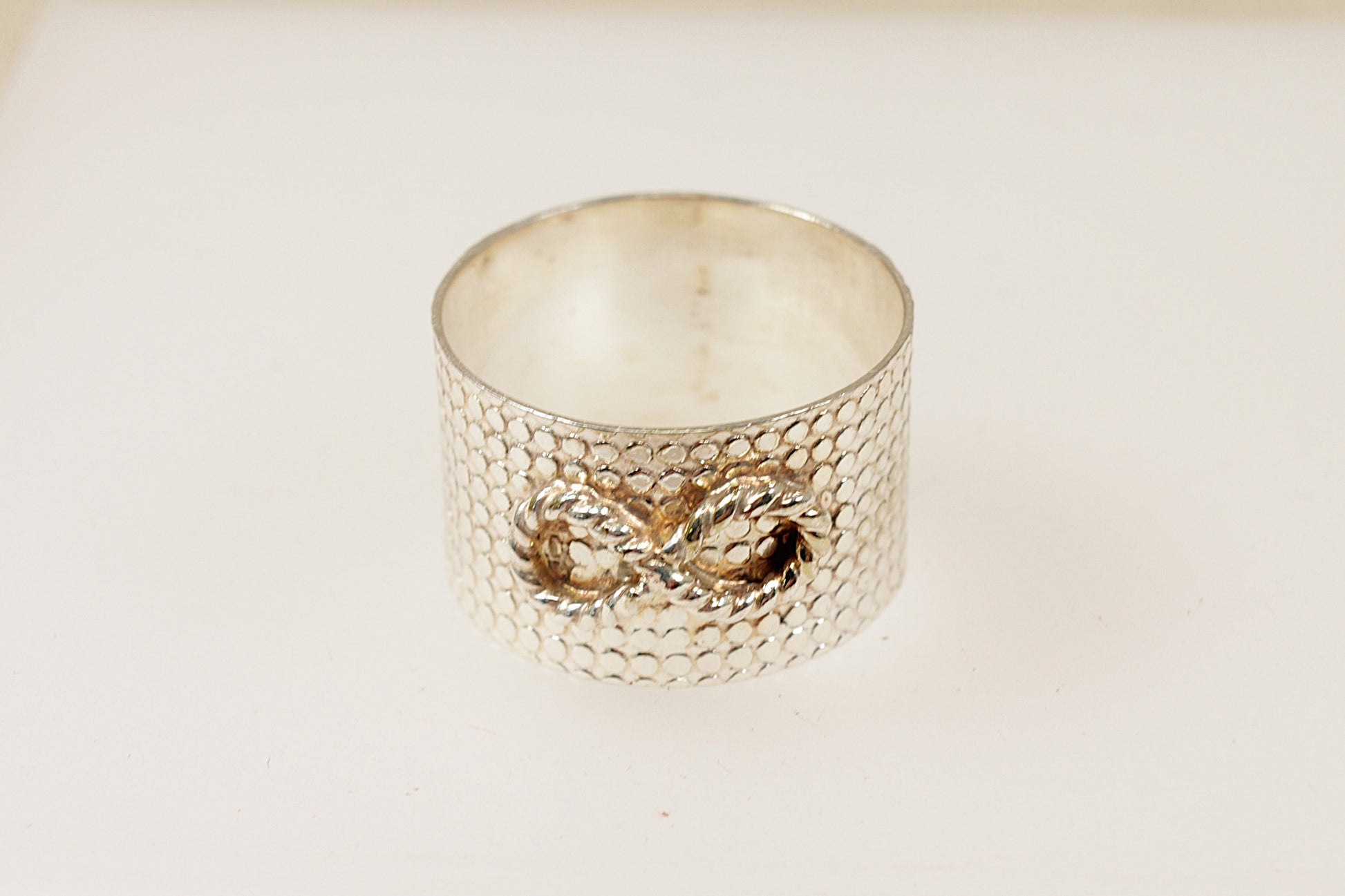 A silver band ring with an engine-turned pattern and embossed rope design, Wear as a finger or thumb ring, Suitable for any gender, It is in excellent condition and stamped 925 for sterling silver. UK Finger size Z.