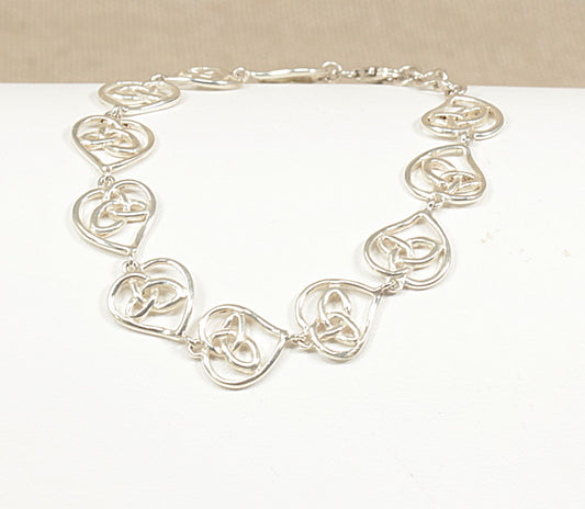 Silver Bracelet-with heart shaped links on a white background