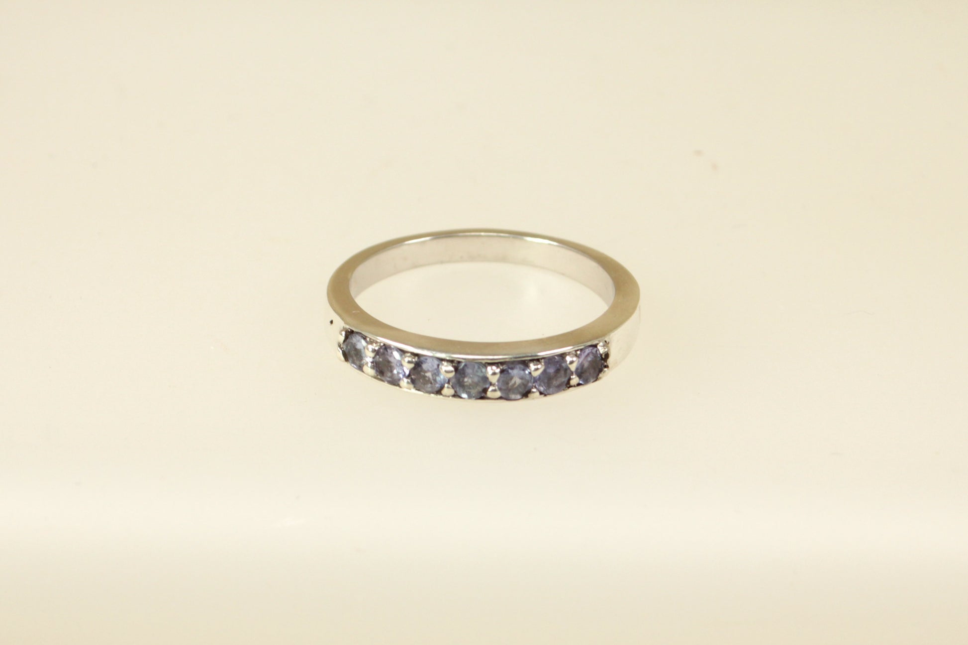 This pretty silver ring has 7 round Iolite gemstones set in handcrafted silver across the band. It is in excellent condition and inside the band it is stamped 925 for sterling silver. Band width: 4mm

UK Finger size: S