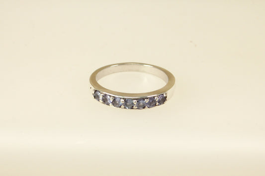 This pretty silver ring has 7 round Iolite gemstones set in handcrafted silver across the band. It is in excellent condition and inside the band it is stamped 925 for sterling silver. Band width: 4mm

UK Finger size: S