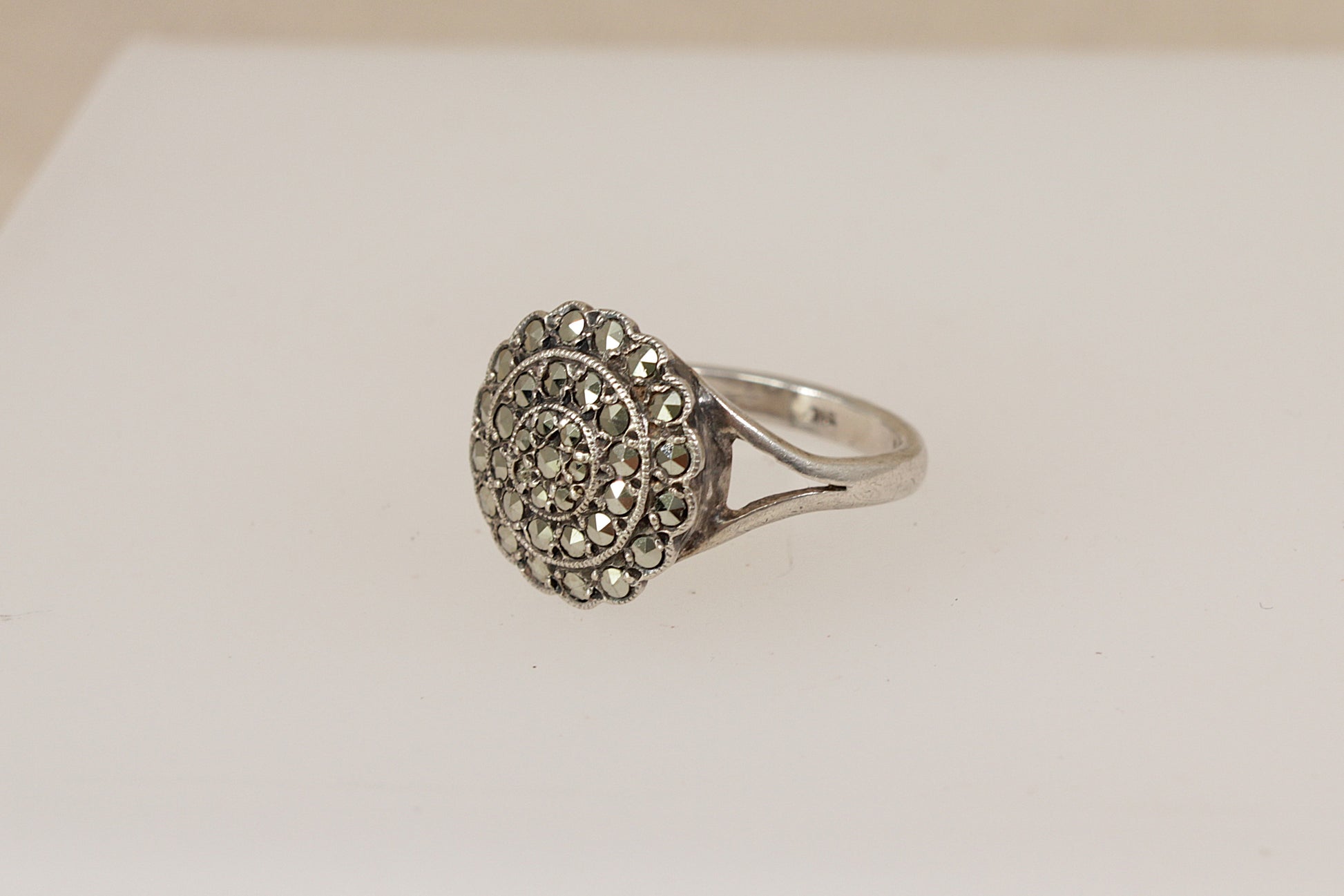 Silver art deco marcasite  ring with intricate design on a light background