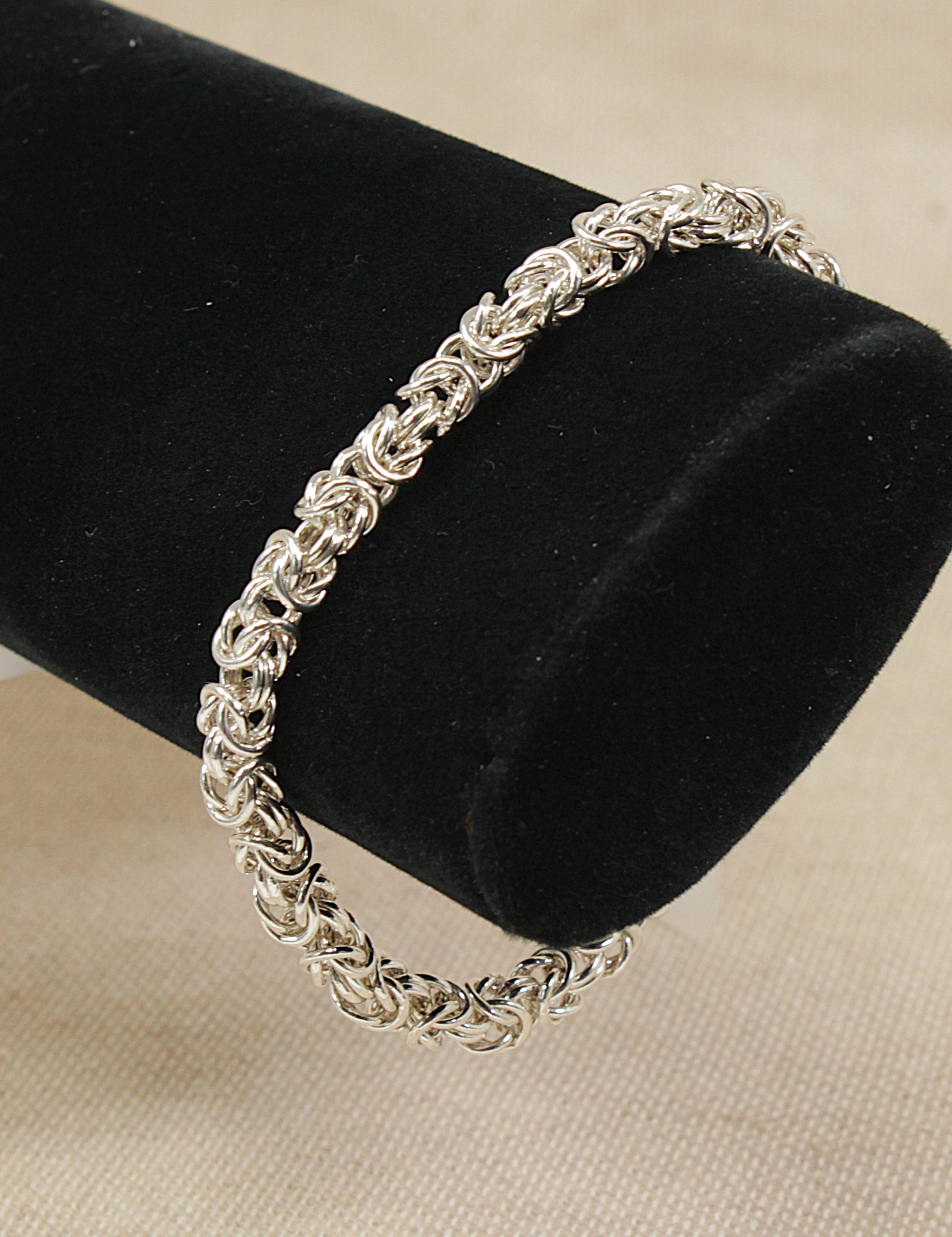 Silver Italian rope link bracelet on a black velvet cushion