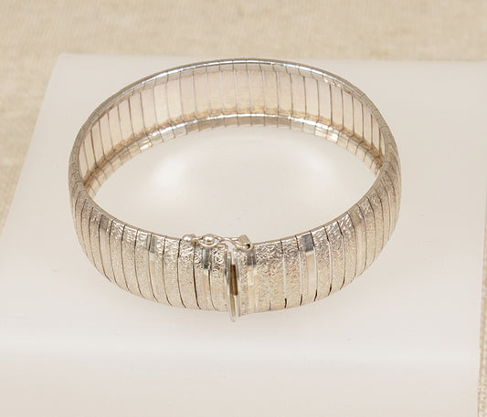 Silver Italian flexiable bracelet on a light beige background