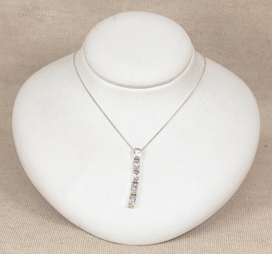 Silver necklace with a pendant on a white jewelry display