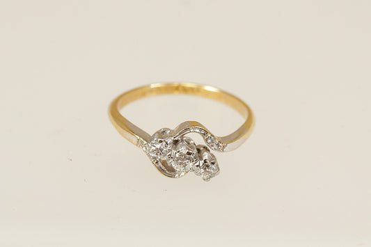 A vintage 18ct gold and platinum diamond twist ring with an estimated 0.15 carat diamonds, circa 1930's, uk finger size O. 
