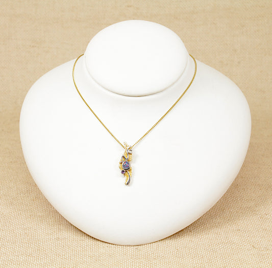This beautiful 9ct Gold ‘Studio’ design piece from the 1970’s was handcrafted with an emphasis on artistry and originality, the pendant crafted in 9ct Gold has a vibrant Opal that flashes blues, reds and orange, sitting in the centre of the pendant with accented cabochon cut Amethyst and Moonstone gemstones.