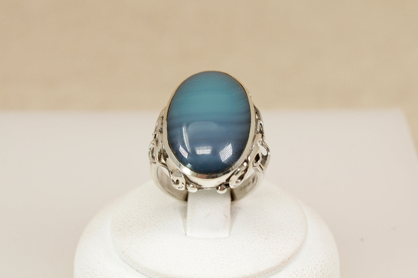 A beautifully crafted sterling silver statement ring, featuring an eye-catching oval cabochon of Blue and Green Banded Agate, Inside the band, the ring bears full Sheffield hallmarks for 1998, UK finger size O.