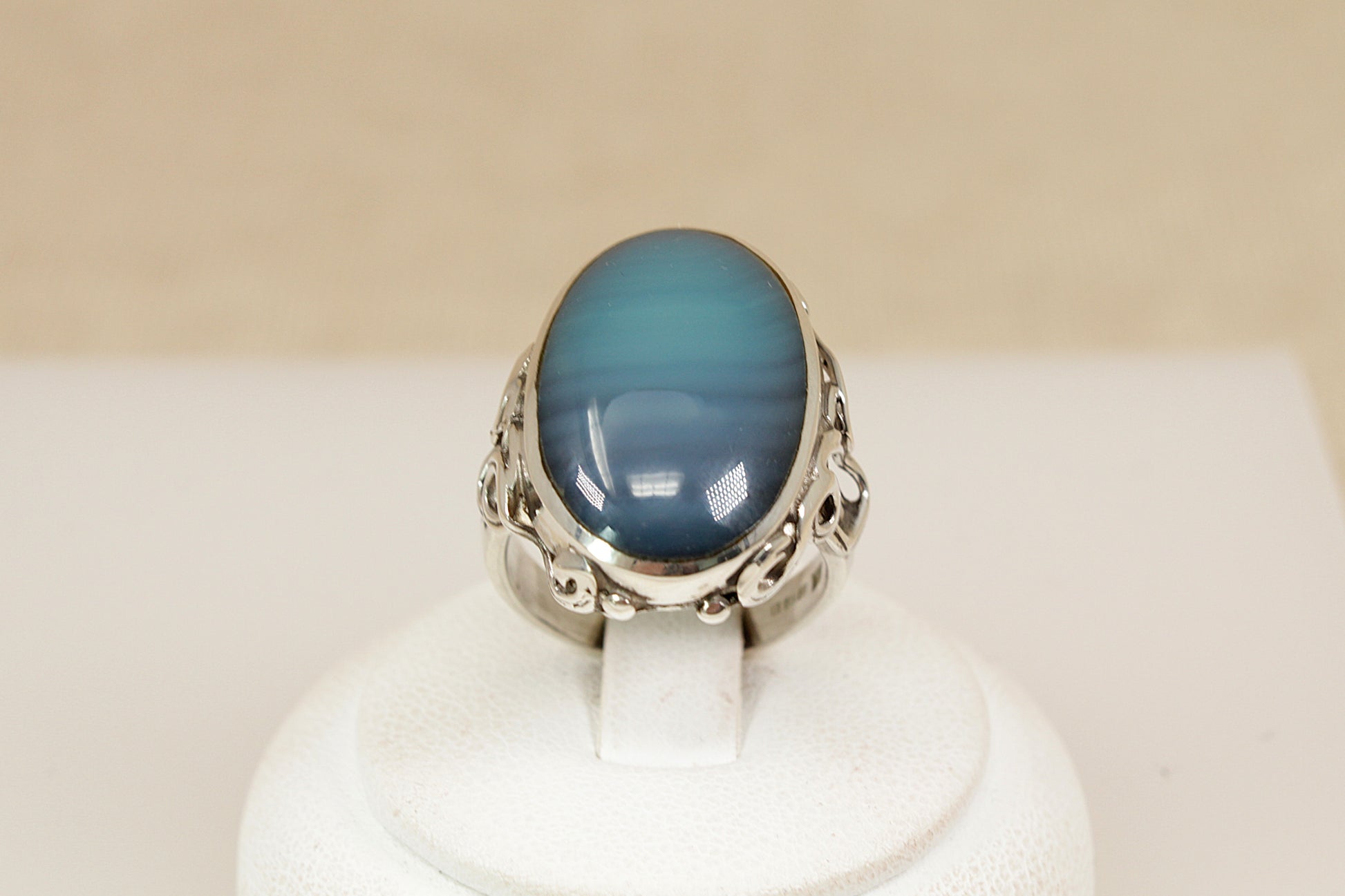 A beautifully crafted sterling silver statement ring, featuring an eye-catching oval cabochon of Blue and Green Banded Agate, Inside the band, the ring bears full Sheffield hallmarks for 1998, UK finger size O.