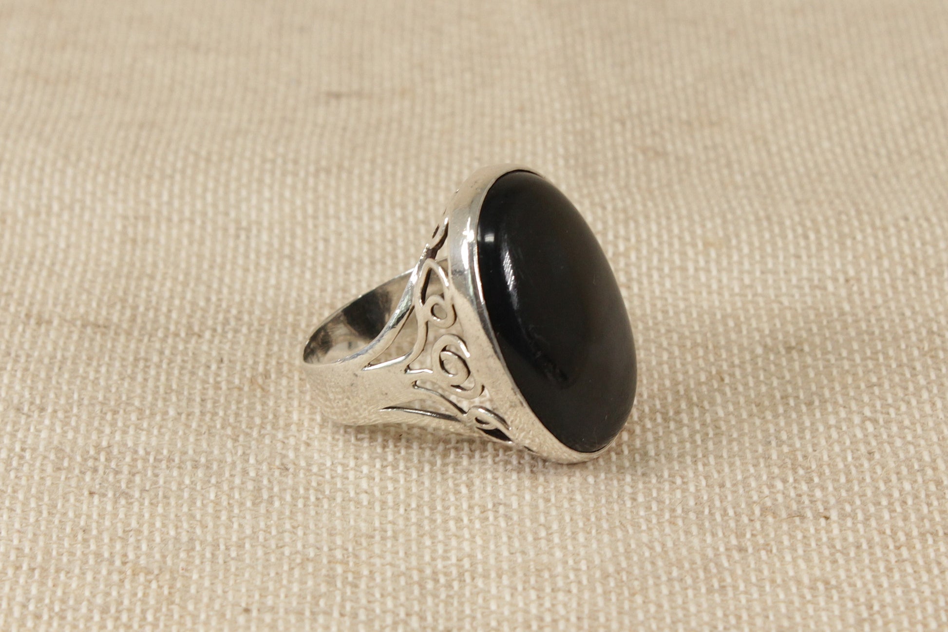 This lovely ring makes a statement! 
It has a beautiful piece of oval Black Agate set in a decorative handcrafted solid silver setting. It is in excellent condition and inside the band it is Hallmarked for London 1981. 
It looks amazing on the finger. UK finger size W.