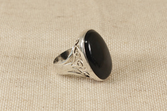 This lovely ring makes a statement! 
It has a beautiful piece of oval Black Agate set in a decorative handcrafted solid silver setting. It is in excellent condition and inside the band it is Hallmarked for London 1981. 
It looks amazing on the finger. UK finger size W.