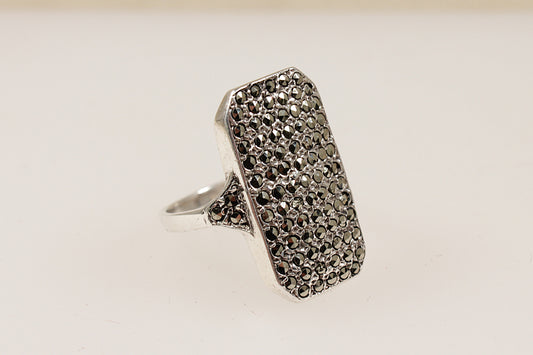 A vintage sterling silver ring with a large rectangular shape encrusted with Marcasite stones.
