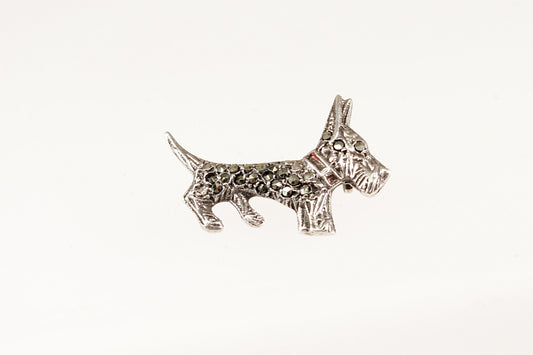 Silver marcasite scotti dog-shaped brooch on a white background