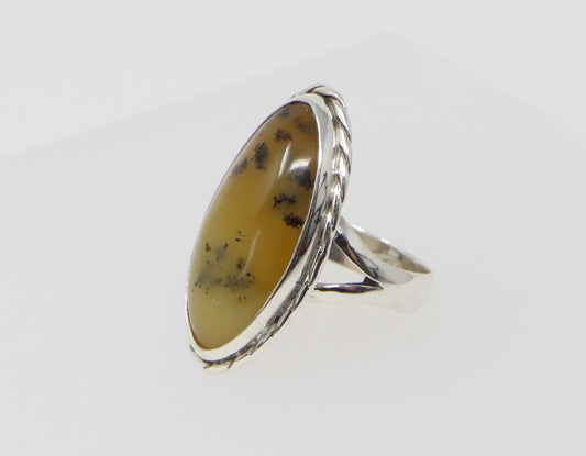 This elegant silver ring is finely made and has a navette shaped piece of Moss Agate set in a beautifully decorated silver setting. Inside the band it is stamped 925 for sterling silver. UK finger size N.