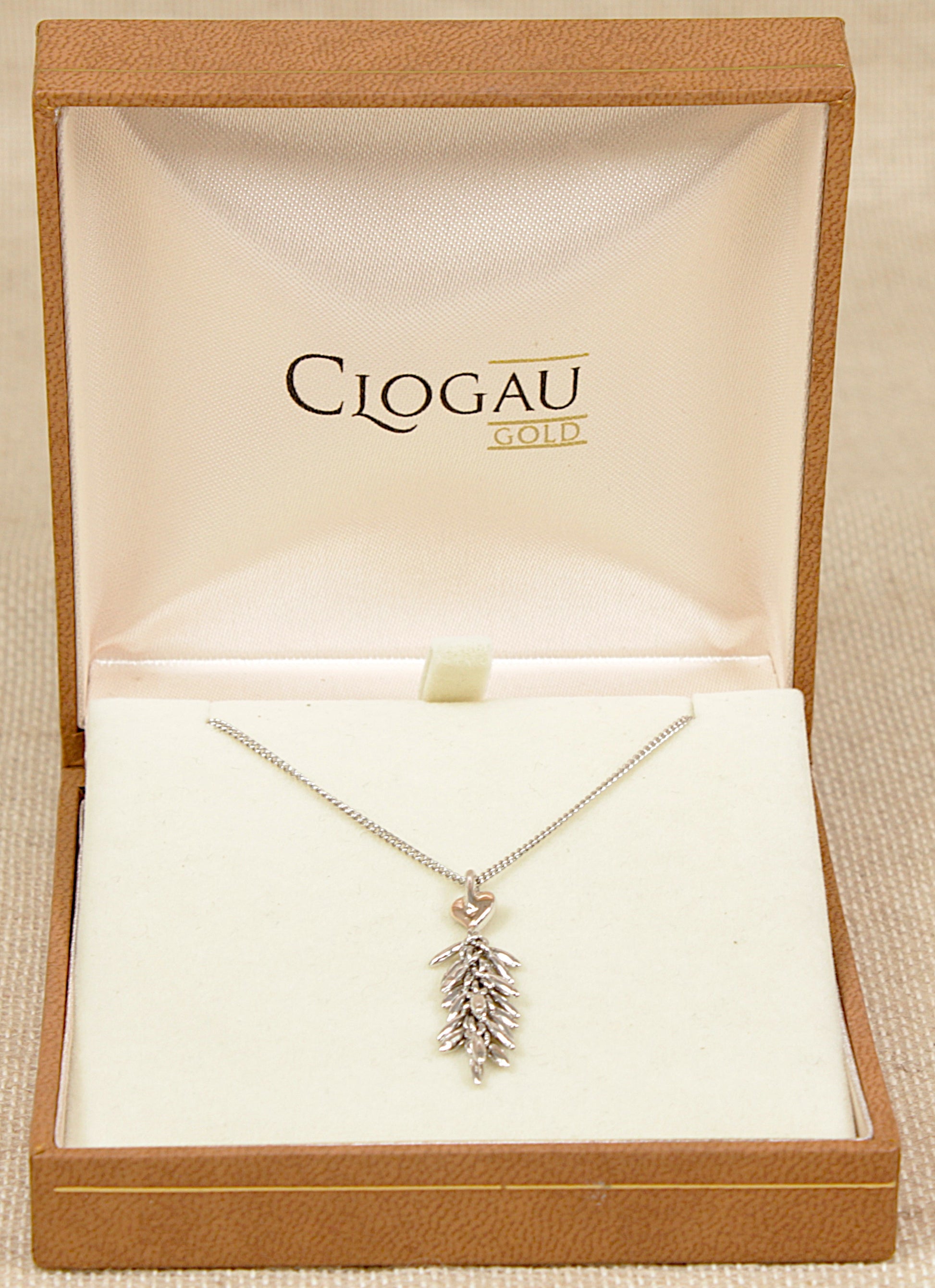 Silver and gold clogau necklace with a leaf pendant in a Clogau Gold box.