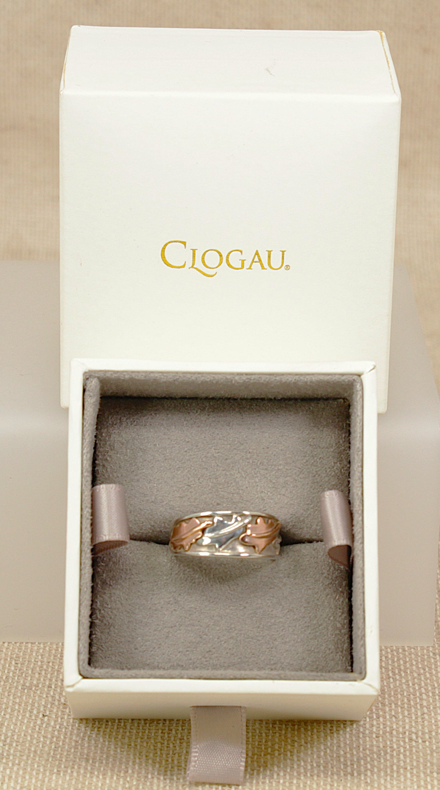 Clogau Silver and rare welsh gold ring with vine leaf  gold accents on a light gray background