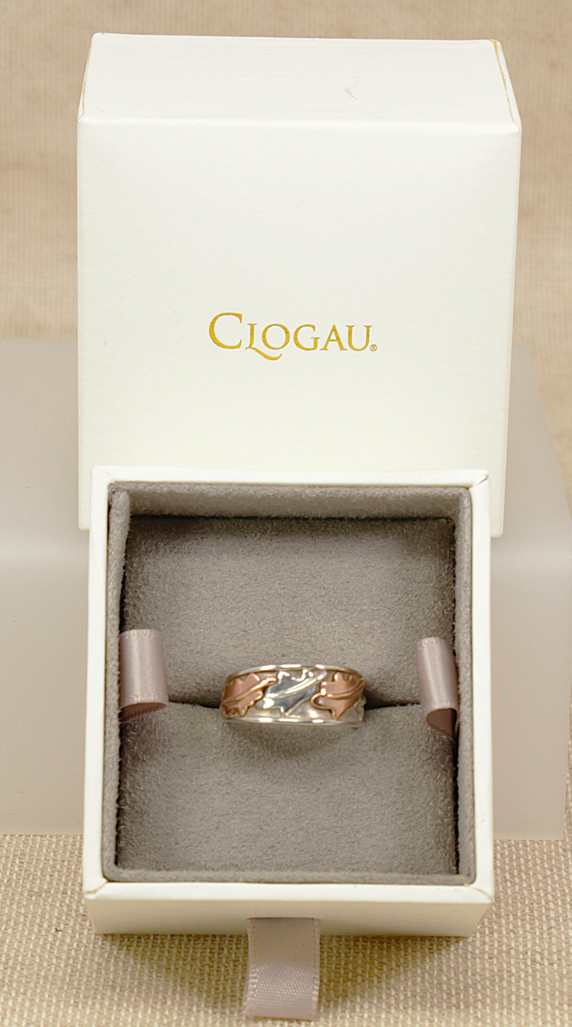 Clogau Silver and rare welsh gold ring with vine leaf  gold accents on a light gray background